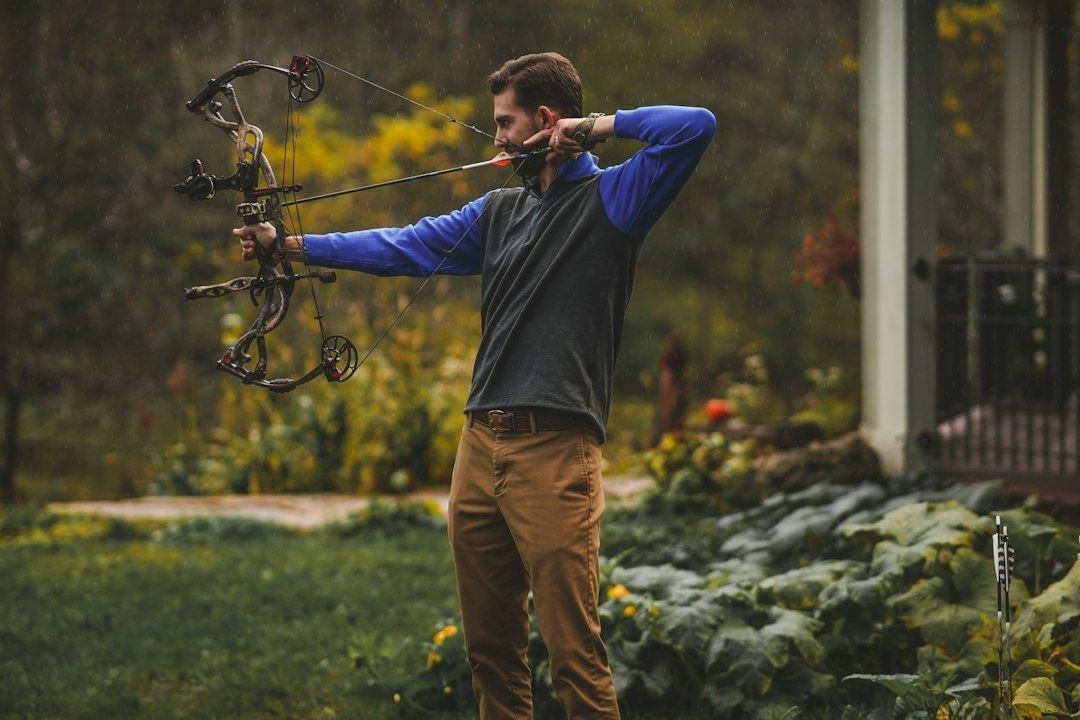 Archer drawing a compound bow with a steady back tension posture