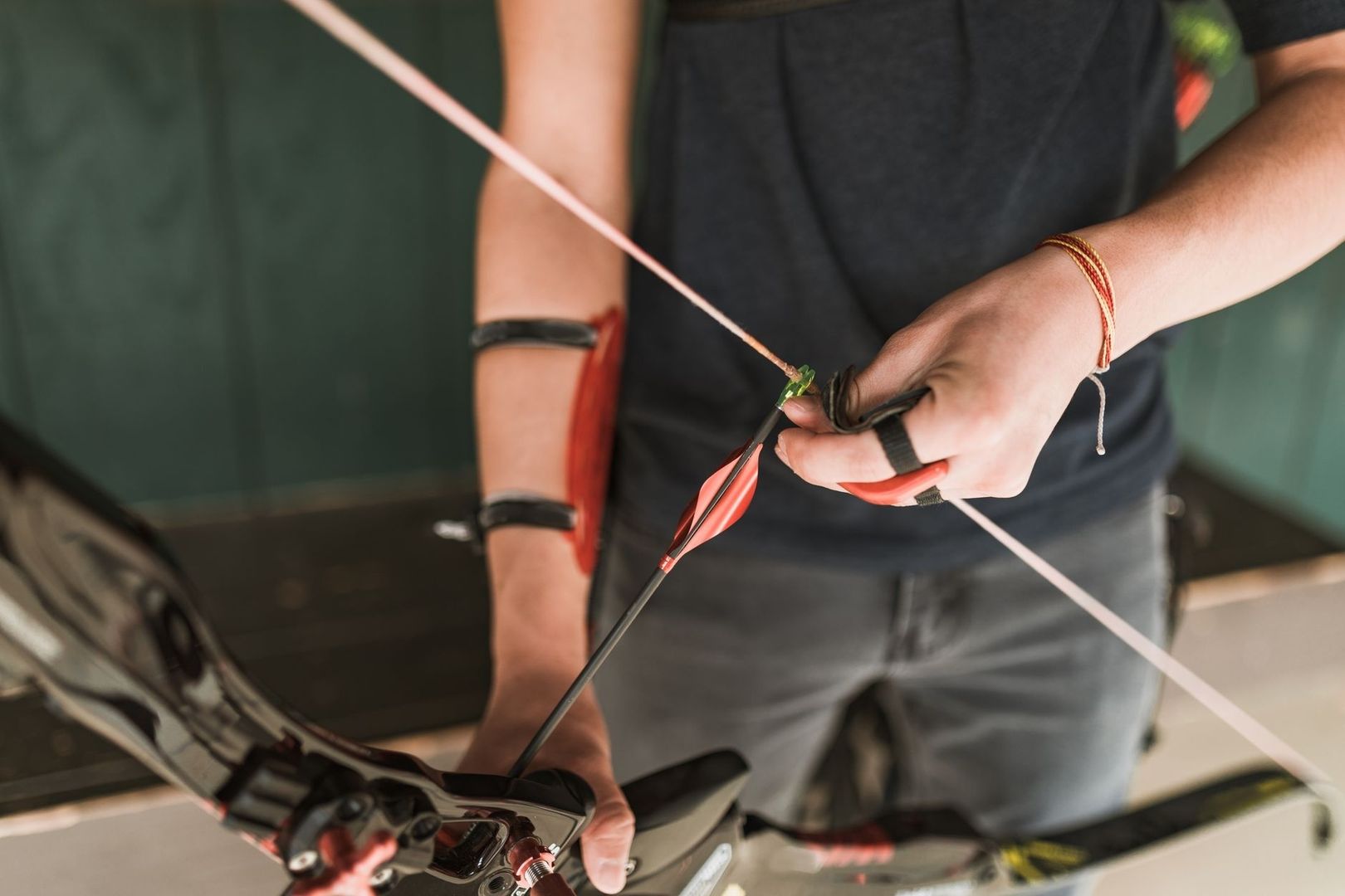 Archer adjusts an arrow on a recurve bow during tuning